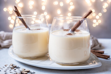 Traditional Christmas drink eggnog with cinnamon and Gingerbread man cookies