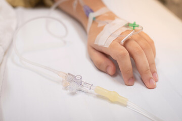 Close-up of 3-way pipe connected to the saline solution tube for intravenous infusion saline...