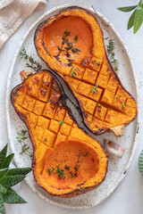 Tray with roasted butternut squash pumpkin and herbs