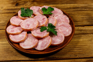 Ham sausage on a plate on wooden table