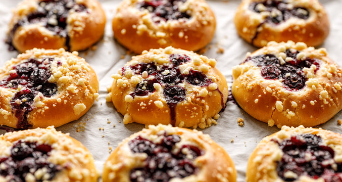 Yeast sweet rolls with the addition of blueberries and butter crumble close up view.  Traditional kolaches