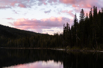 Sun setting on a cloudy evening at hell roaring lake in central Idaho, part of the sawtooth mountain range. 