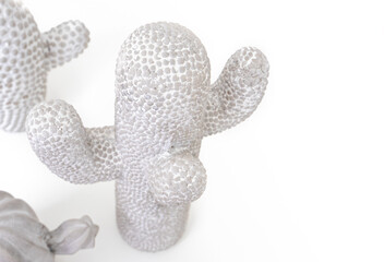 Closeup of multiple cactus made out of  stone or clay. The cactus are bumpy. Interior decoration. Monochromatic color theme with copy space. Isolated on white.