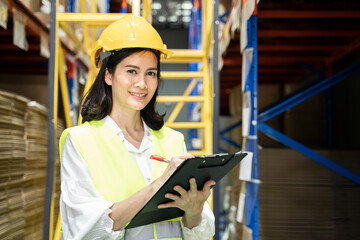 Asian female engineer worker working in shipping industrial warehouse
