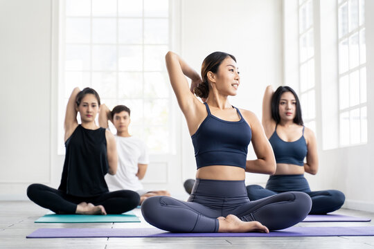 Asian Group Sporty People Learning Yoga Lesson With Coach Trainer.