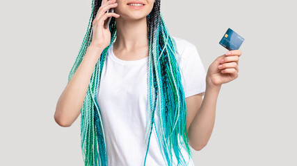 Millennial generation woman with blue hair braids. Cheerful lady verifying credit card personal data on phone unrecognizable isolated on white. Mobile banking. Cashless payment. Customer support.