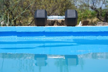 Dumbbell at side of Swimming Pool