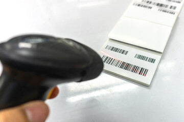 Man hold scanner and scan for reading barcode for transfer data to computer.