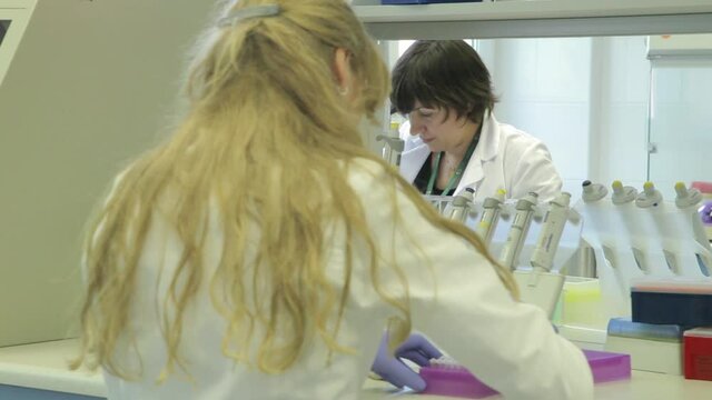 Two Lady Doctors testing Samples in laboratory