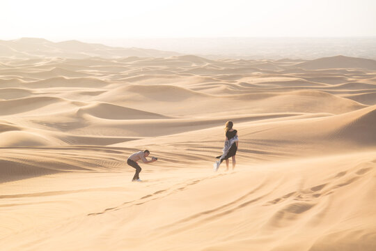 Exclusive photo shoot of a woman in the desert. Magazine advertising filming. The work of the photographer and model in the desert of Dubai