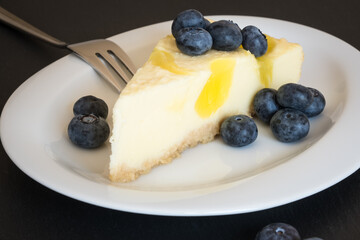 Lemon cheescake with blueberries on the plate, close up