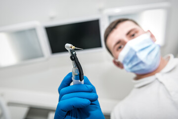 dentist with a tool for nerve extraction