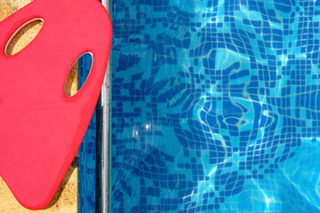 red floating pad near a swimming pool