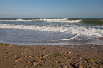 Picturesque sea landscape, wave white foam. Natural waves and beach.