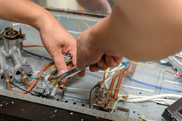 man fixing a gas cooker