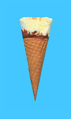 side view vanilla flaovr ice cream cone with a bite on a blue background