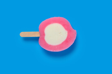 top view fresh honey peach shape and flavor popsicle on a blue background