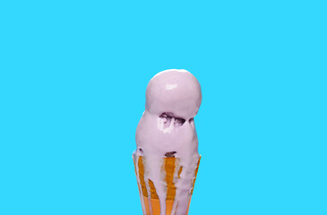 half melted sweet potato ice cream cone on blue backgroud