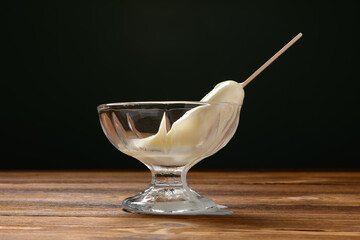 glass cup with a half melted milk popsicle