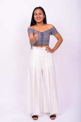 Portrait of happy young beautiful Asian woman with braces