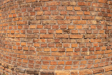 Cylindrical red brick wall. The base of an old factory chimney.
