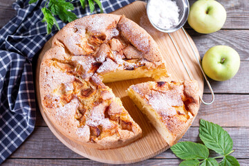 Tasty homemade apple pie on a wooden board on the table.