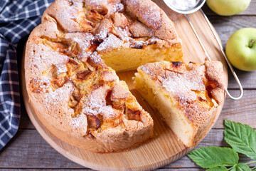 Tasty homemade apple pie on a wooden board on the table.
