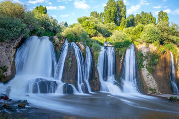 Fototapeta na wymiar Muradiye waterfall, which is located on the Van - Dogubeyazit highway, a natural wonder often visited by tourists in Van, Turkey