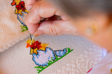 Woman making cross stitch in full color