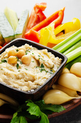 Low angle view at vegetable Hummus dip dish topped with chickpeas and olive oil
