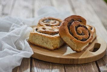 Tasty buns with raisins on a brown rustic wooden table. fresh bakery. breakfast. bread. top view