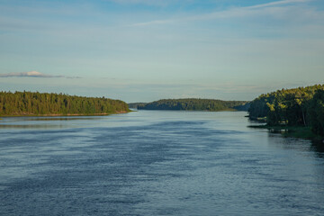 wooded banks of a wide river