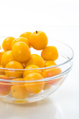 yellow cherry plums on the white background