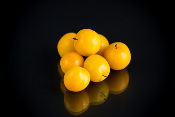 yellow cherry plums on the black background