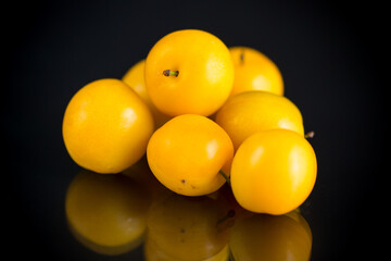 yellow cherry plums on the black background