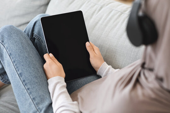Muslim Woman Relaxing At Home, Holding Digital Tablet With Black Screen, Mockup