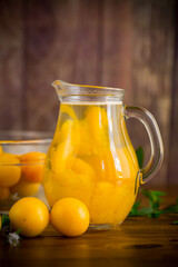 sweet cooked compote in a glass decanter of ripe yellow cherry plum
