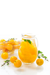 sweet cooked compote in a glass decanter of ripe yellow cherry plum