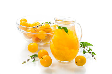 sweet cooked compote in a glass decanter of ripe yellow cherry plum