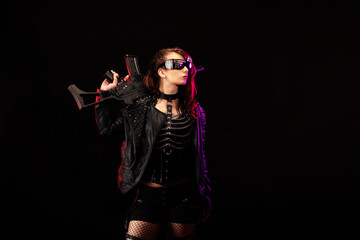 Young woman dressed in a studded leather jacket, a pair of cyberpunk glasses, holding an assault rifle in her hands