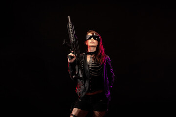 Young woman dressed in a studded leather jacket, a pair of cyberpunk glasses, holding an assault rifle in her hands