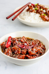 Popular American-Chinese Takeout Food General Tso's Chicken with Rice in a Bowl Vertical Photo