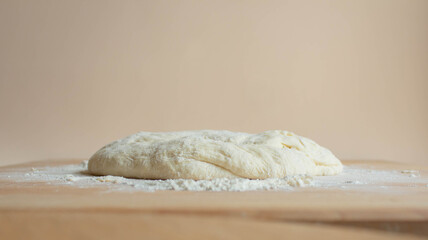 Preparing dough for homemade pastry bread, pizza, pasta on the background of a wooden table.