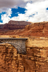 The arch bridge connected to the bedrock above the Colorado river near Navajo bridge, AZ, USA