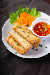 Fried spring rolls on a white plate