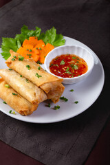 Fried spring rolls on a white plate