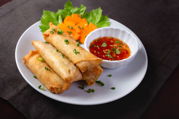 Fried spring rolls on a white plate