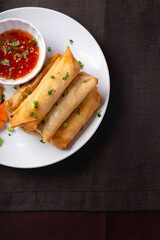 Fried spring rolls on a white plate