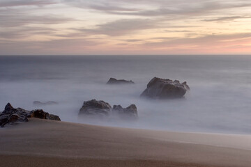 Fototapeta na wymiar Sea rocks at dusk