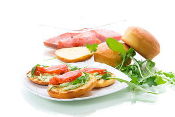 sandwich with fried bun, cheese spread and red fish in a plate